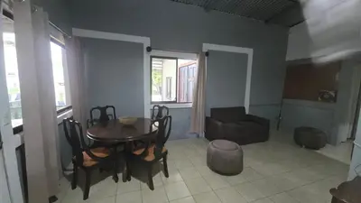 a living room with a table and a couch at Stay at Alexas Nature House in Nuevo Arenal