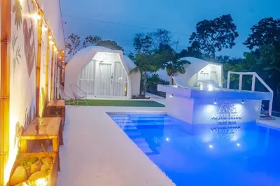 a resort with a swimming pool and a building at Arenal Igloo Private House in Fortuna