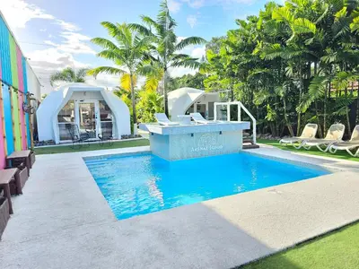 a pool with a hot tub in a resort at Arenal Igloo Private House in Fortuna
