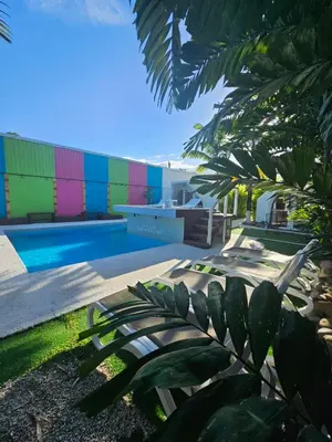 a colorful building with a pool in front of it at Arenal Igloo Private House in Fortuna