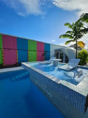 a resort swimming pool with a colorful wall at Arenal Igloo Private House in Fortuna