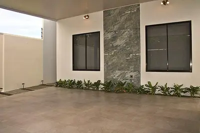 an empty room with plants and windows in a building at Villa Libélula in Quepos
