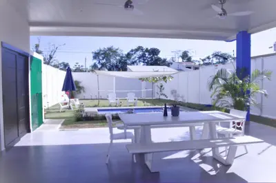 a patio with a ping pong table and benches at Villa Libélula in Quepos