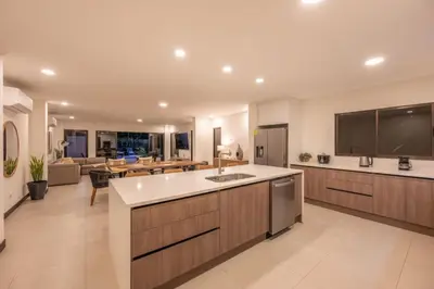 a large kitchen and living room with a large island at Flamingo Oasis in Playa Flamingo