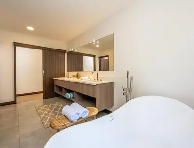 a bathroom with a sink and a large mirror at Flamingo Oasis in Playa Flamingo