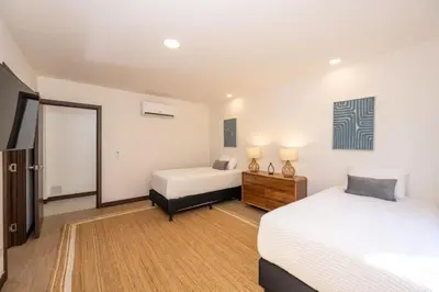 a bedroom with two beds and a mirror at Flamingo Oasis in Playa Flamingo
