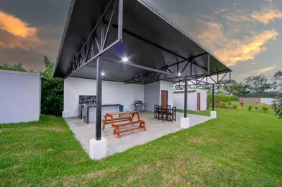 a pavilion with benches and a table in a field at Villa Montreal in Guayabal