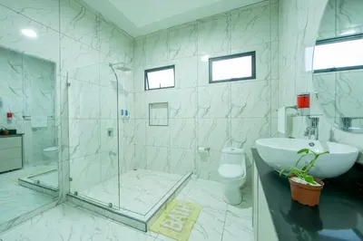 a bathroom with a shower and a toilet and a sink at Villa Montreal in Guayabal