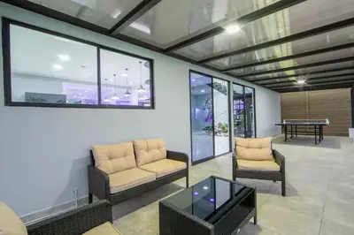 a living room with two chairs and a table at Villa Montreal in Guayabal