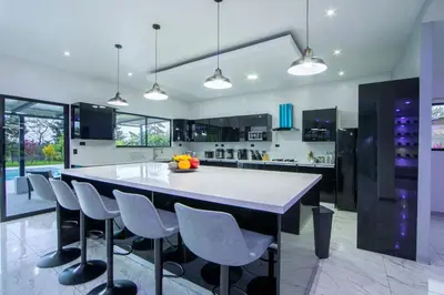 a kitchen with a large white table and chairs at Villa Montreal in Guayabal
