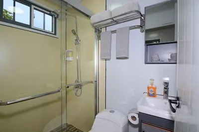 a bathroom with a shower and a toilet and a sink at Cabaña Los Lirios in Monteverde Costa Rica