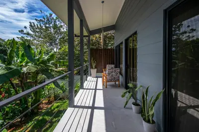 a porch of a house with a chair and plants at Uvita Tropical Bliss, Pool, Close to it all, 3bdrs in Uvita