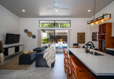 a kitchen and living room with a couch and a sink at Uvita Tropical Bliss, Pool, Close to it all, 3bdrs in Uvita