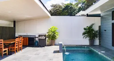 a patio with a swimming pool and a table and a house at Uvita Tropical Bliss, Pool, Close to it all, 3bdrs in Uvita