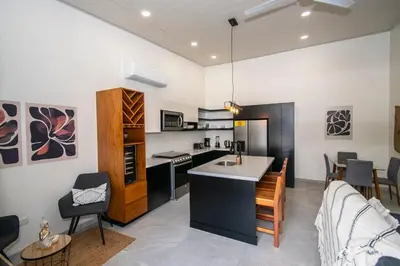 a kitchen and living room with a couch and a table at Uvita Tropical Bliss, Pool, Close to it all, 3bdrs in Uvita