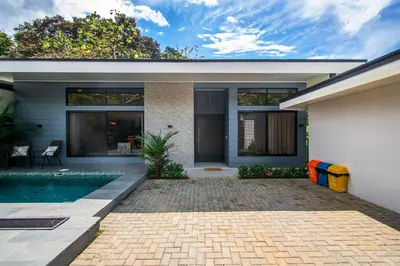 a house with a swimming pool in front of it at Uvita Tropical Bliss, Pool, Close to it all, 3bdrs in Uvita