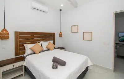 a bedroom with a bed with a towel on it at 5 min walk to Uvita beach, pool, 3 bdr, AC! in Uvita
