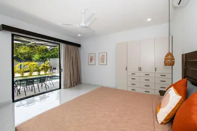 a bedroom with a bed and a dining room at 5 min walk to Uvita beach, pool, 3 bdr, AC! in Uvita