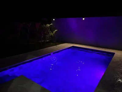 a blue swimming pool in a dark room at 5 min walk to Uvita beach, pool, 3 bdr, AC! in Uvita