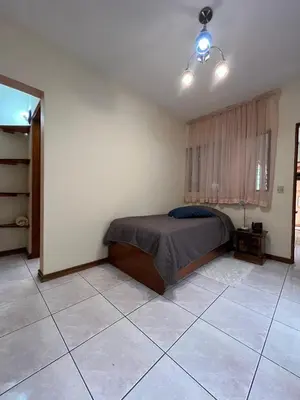 a bedroom with a bed and a tiled floor at Lotus apartment in San José
