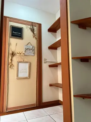 a hallway with a mirror and some shelves at Lotus apartment in San José