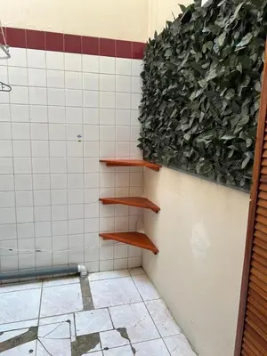 a wall with wooden shelves in a bathroom at Lotus apartment in San José