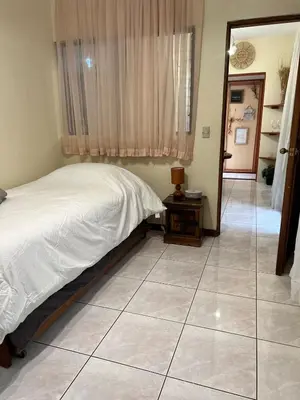 a bedroom with a bed and a tiled floor at Lotus apartment in San José