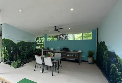 a dining room with blue walls and a table and chairs at Casa Rio Tortuga - 2 Rooms in Tortugal