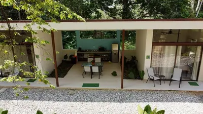 a screened in patio with a table and chairs at Casa Rio Tortuga - 2 Rooms in Tortugal