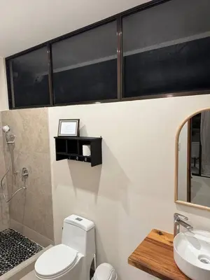 a bathroom with a toilet and a sink at Casa Rio Tortuga - Butterfly in Ojochal