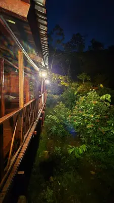 a house with lights on the side of it at night at Green Horizon in Upala
