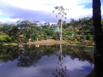 a reflection of a house in a pond at Rincon Verde in Bijagua