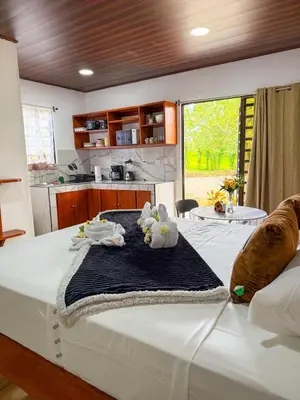 a bedroom with a bed with two stuffed animals on it at Refugio Las Cortezas in Fortuna