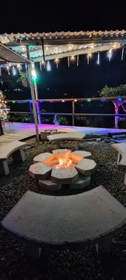 a fire pit in a yard at night at Cabañas La Madriguera