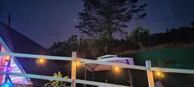 a house with lights on a fence at night at Cabañas La Madriguera