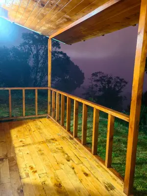 a view from the deck of a cabin in the woods at Cerro Lodge & Gardens in Cartago