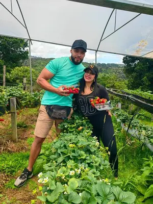 a man and a woman standing in a garden at Cerro Lodge & Gardens in Cartago