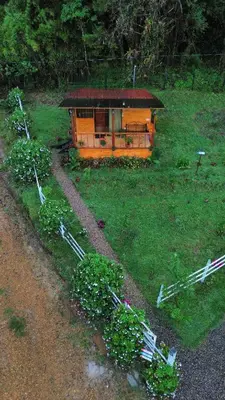 a small house in the middle of a field at Cerro Lodge & Gardens in Cartago