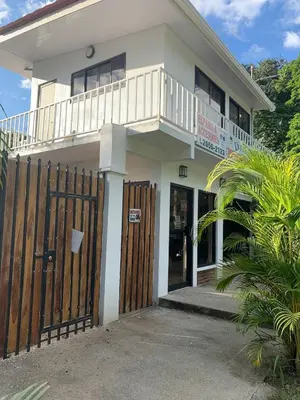 a white house with a wooden fence in front of it at Casa Mia in Sámara