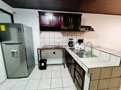 a small kitchen with a sink and a refrigerator at Apartment JESALU, just 3 minutes from the Airport in San Antonio