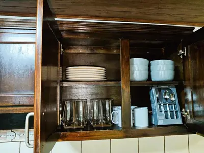 a cabinet with plates and cups and dishes in it at Apartment JESALU, just 3 minutes from the Airport in San Antonio