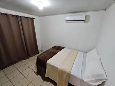 a bedroom with a bed and a air conditioner at Apartment JESALU, just 3 minutes from the Airport in San Antonio
