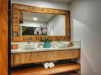 a bathroom with two sinks and a large mirror at Sassy Sloth Villa in Fortuna