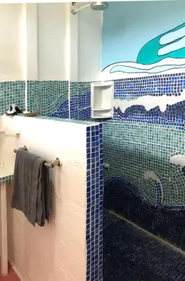 a bathroom with a shower and a sink and a mirror at Ojochal, Costa Rica artist owned property in Ciudad Cortés
