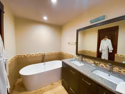 a bathroom with two sinks and a large mirror at 2 Bedroom Condo in Croc's Casino Resort in Jacó