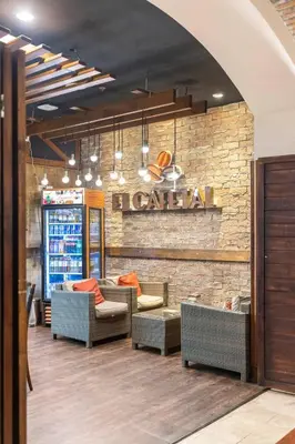 a restaurant with couches and a sign on a brick wall at 2 Bedroom Condo in Croc's Casino Resort in Jacó