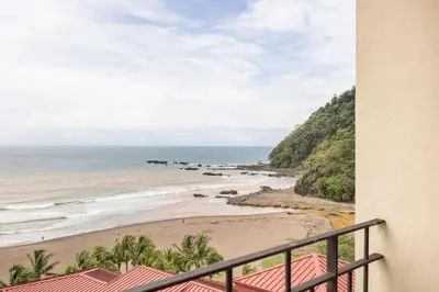 a view of the beach from the balcony of a condo at 2 Bedroom Condo in Croc's Casino Resort in Jacó