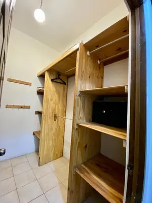 a walk in closet with wooden shelves at Casa cerca Aeropuerto in Tapantí