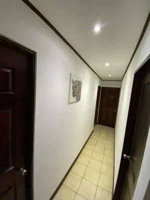 a hallway with a door and a tile floor at Casa cerca Aeropuerto in Tapantí