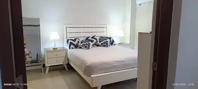 a bedroom with a bed with blue and white pillows at Apartamento céntrico San jose in San José